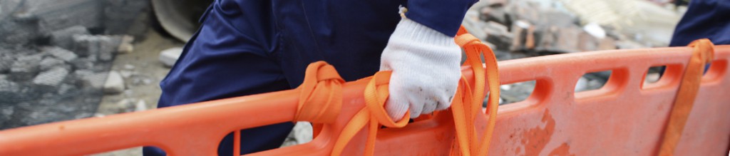 Hand of a person carrying a medical backboard
